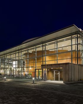 Modern glass building at night time with vivid colors