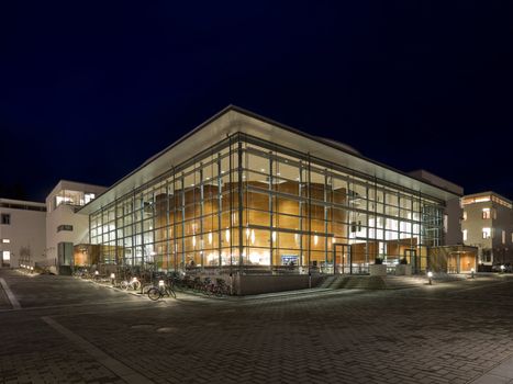 Modern glass building at night time with vivid colors