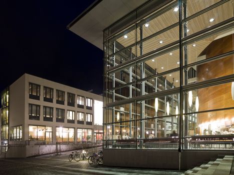 Modern glass building at night time with vivid colors