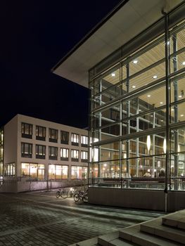 Modern glass building at night time with vivid colors