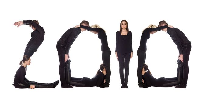 Group of people forming the word '2010', isolated on white background.