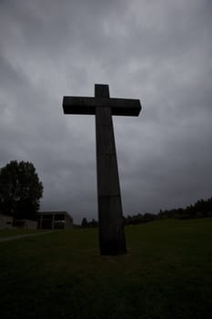 Dark cross against a dramatic grey sky