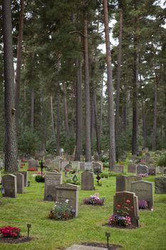 A cemetery at day time with lots of tombstones