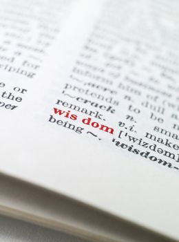 The word 'wisdom' highlighted in a dictionary