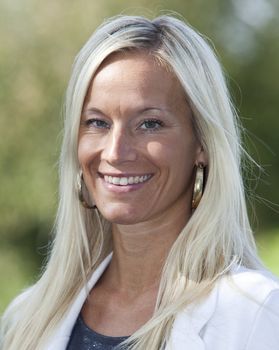 Portrait of a blonde woman smiling.