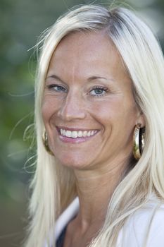 Portrait of a blonde woman smiling.