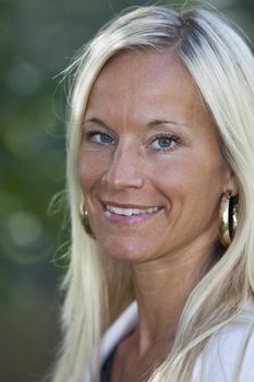 Portrait of a blonde woman smiling.