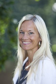 Portrait of a blonde woman smiling.