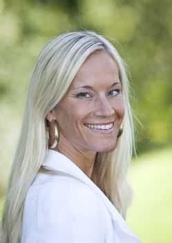 Portrait of a blonde woman smiling.