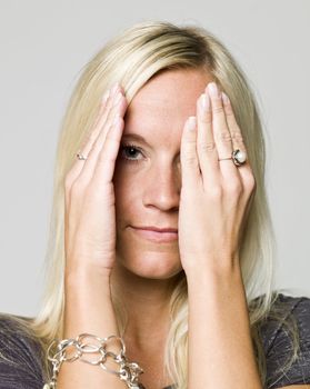 Portrait of a woman hiding in her hands