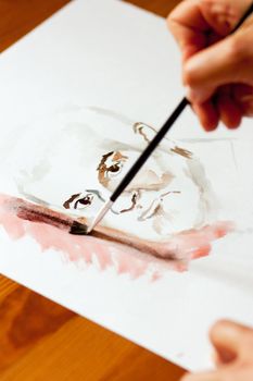 Painter drawing a face with watercolor