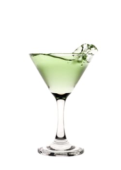 Green liquid splashing in a martini glass.