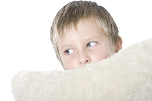 Portrait of boy with white soft pillow 