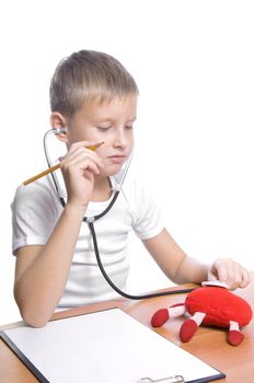 Adorable future doctor 7 years old boy isolated on white 