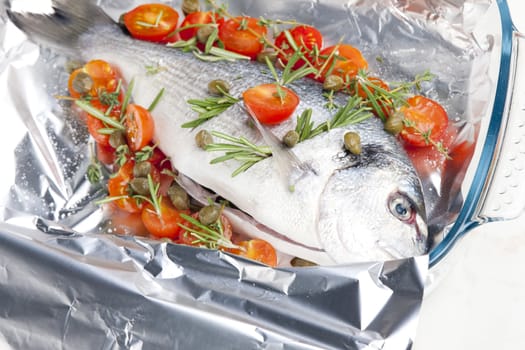 raw bream with herbs and cherry tomatoes