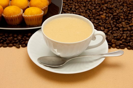 White cup of coffee and coffee beans