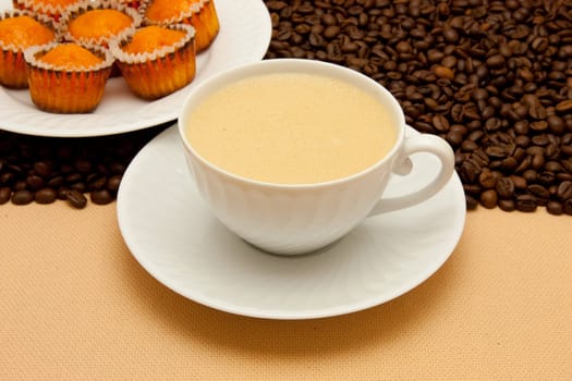 White cup of coffee and coffee beans