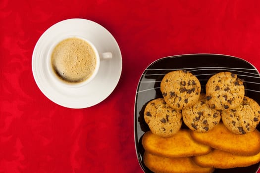 Coffee and cookies on a red background