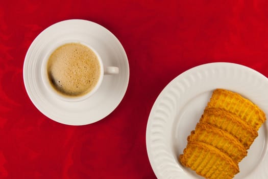 Coffee and cookies on a red background