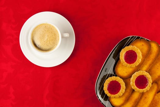 Coffee and cookies on a red background