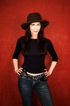 Pretty woman in jeans and a dark felt hat