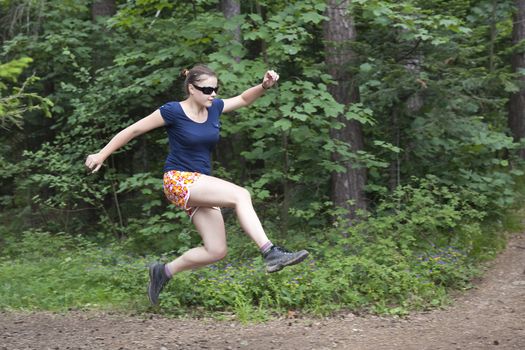 young woman jumping in the forest - Slovak Paradise National Park