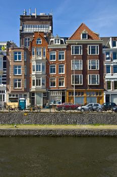 Classic amsterdam view. Residential homes on the canal. Urban scene. Spring.