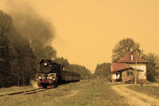 Steam passenger train starting from the small station
