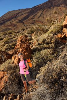 Woman hiking. Young chinese female model hiking / backpacking in beautiful volcanic landscape on the volcano, Teide, Tenerife, Spain. 