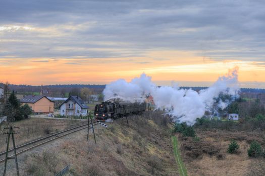 Rural landscape with an old retro steam train

