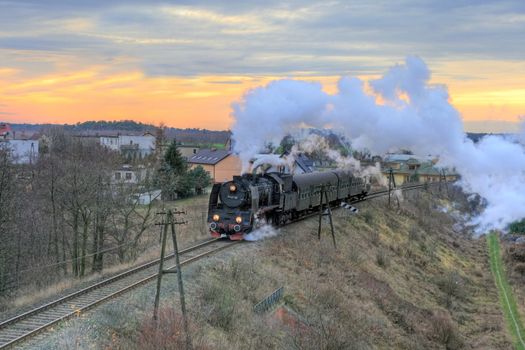 Rural landscape with an old retro steam train
