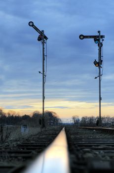 Old railway mechanical semaphores against the dramatic sky
