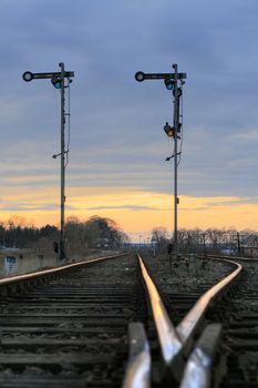 Old railway semaphores and rails against the dramatic sky
