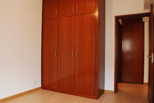 empty room with wooden wardrobe and floor