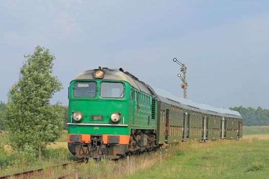 Passenger train passing through polish countryside
