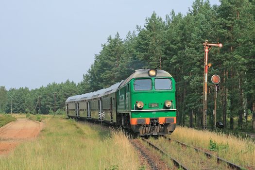 Passenger train passing through polish countryside
