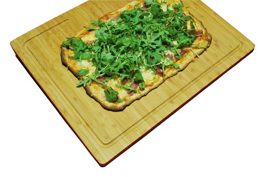 homemade pizza with 3 cheeses with prosciutto and arugula (on wooden board)