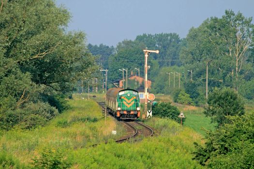 Passenger train starting from the small station
