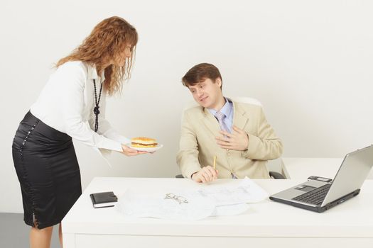 The young woman delivered to the chief a sandwich to a dinner (studio shot)