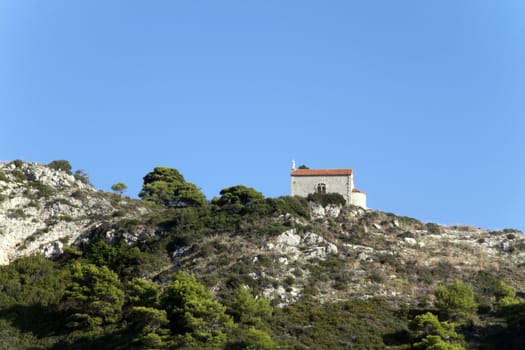 A lone church on the mountain side above