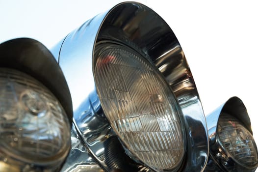 Chromed motorcycle headlights. Close-up. Isolated on white.