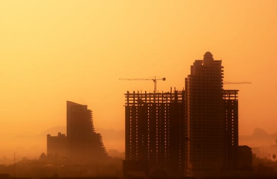 Skyscraper in vibrant colors. Building on the sunset.