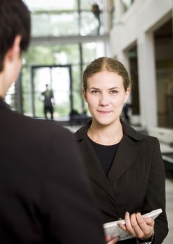 Woman with a folder facing the camera