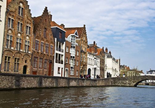 Bruges. Belgium. Medieval houses on the canal. Town Quay and the bridge. Typical building in Bruges.