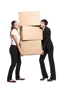 Two women carrying three boxes