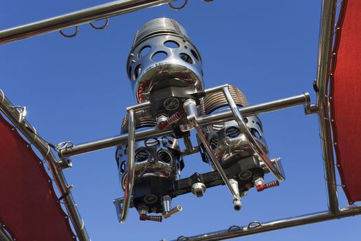 Gas burner of a hot air balloon. Blue sky background.