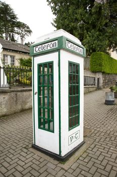 irish white and green phone box at the street