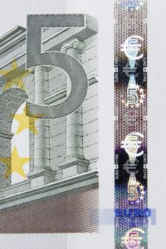 Closeup photo of a part of five euro note including hologram. Macro photo.