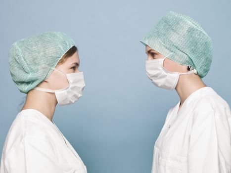 Two nurses towards Turquoise background
