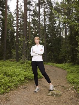 Woman standing in the woods